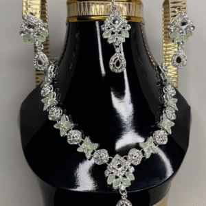 A zircon necklace and earrings displayed on a black mannequin, showcasing their elegant design and sparkling details.