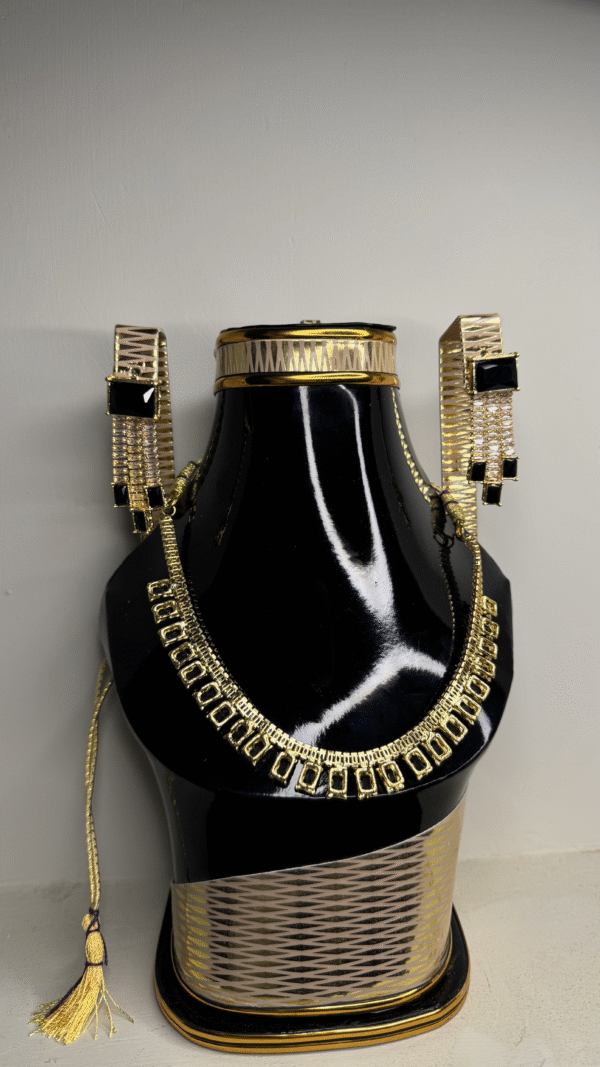 A black mannequin showcasing a zircon necklace and matching earrings set.